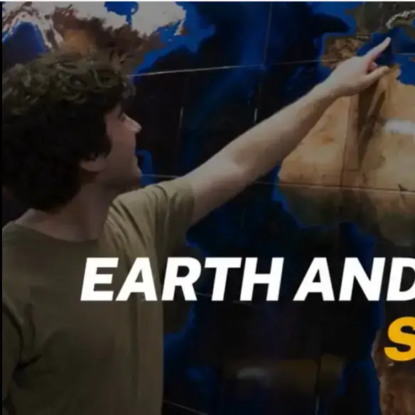 Earth and Spatial Science thumbnail image of a man pointing to a spot on a globe.