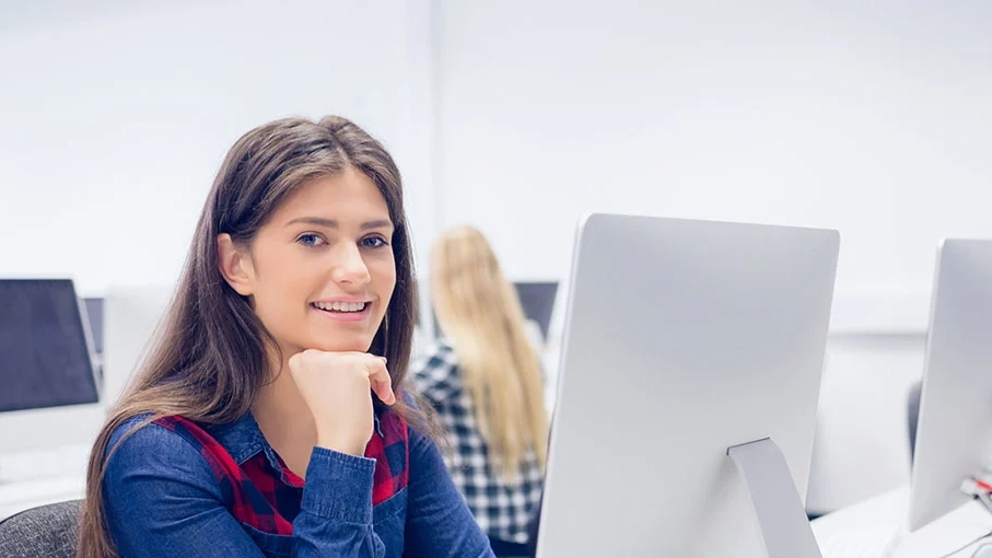 Smiling student working on computer