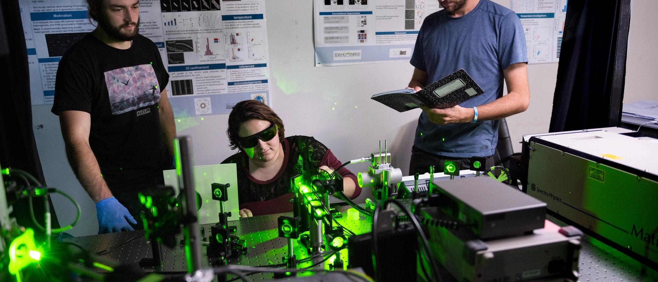 students interacting with optical lab equipment 
