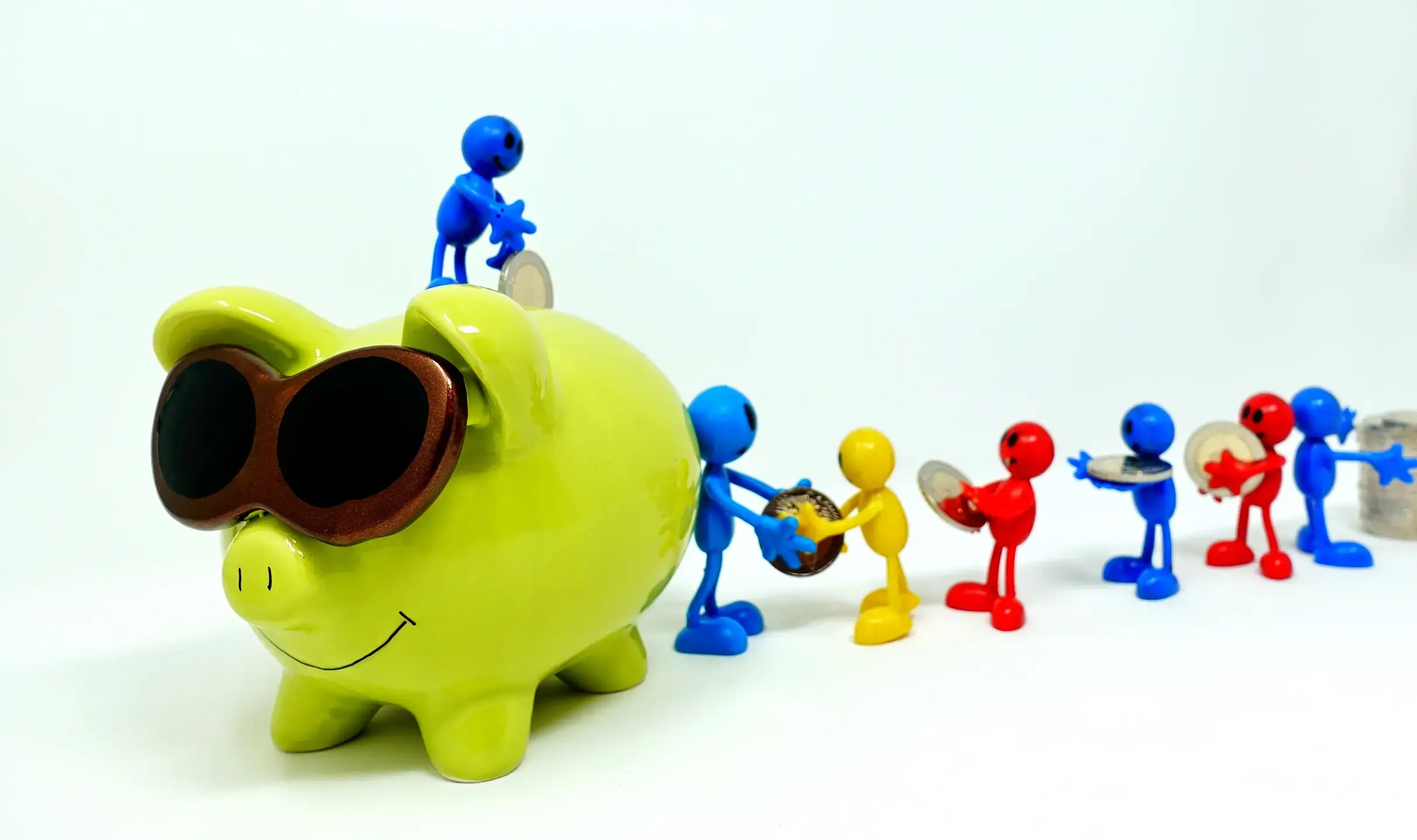 Video cover a green piggy bank with sun glasses and models are adding coins