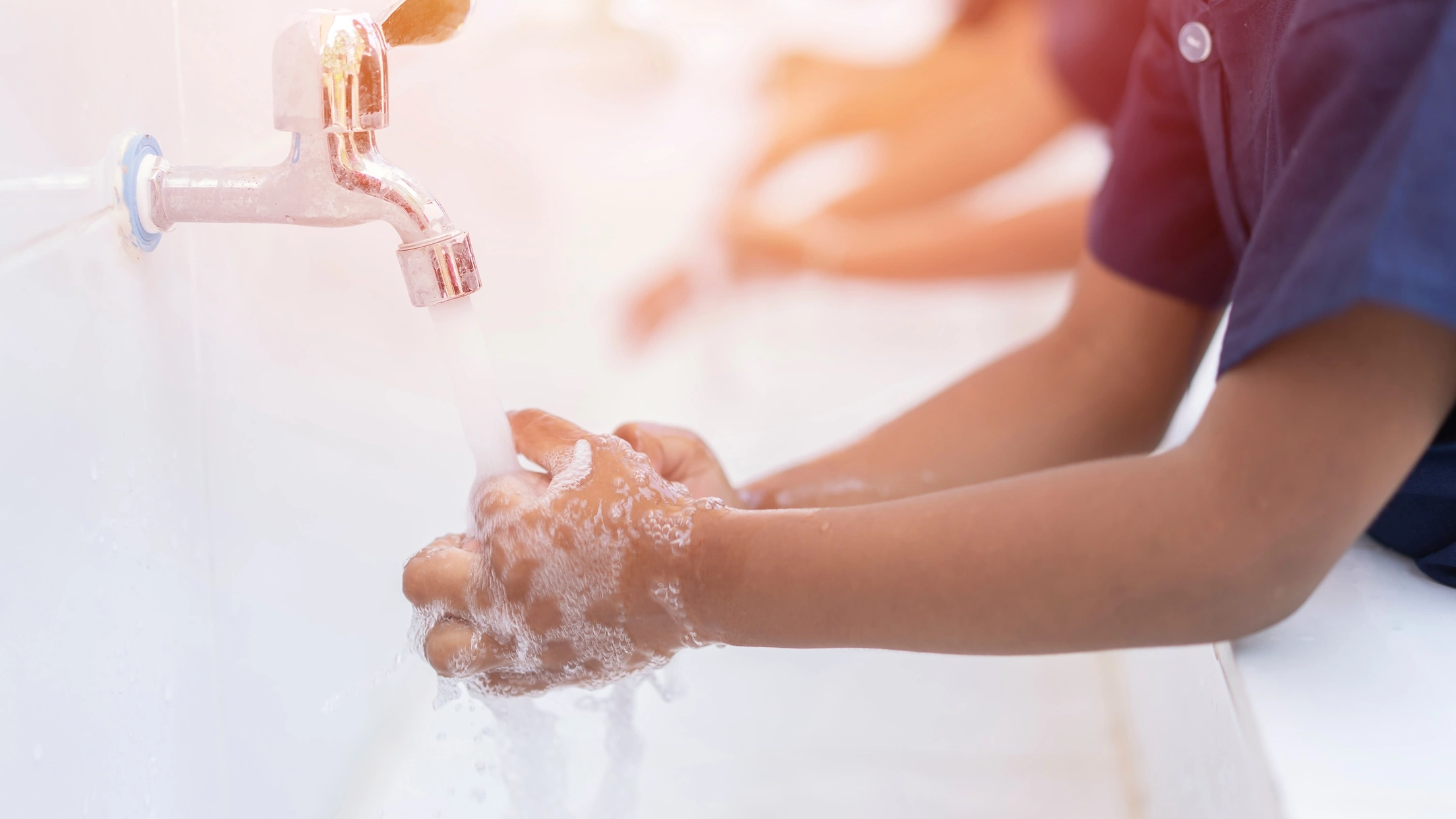 close up hands of children or Pupils At preschool Washing hands with soap under the faucet with water,copy space for text or product you. clean and Hygiene concept.Health and Wellbeing priority extension topic