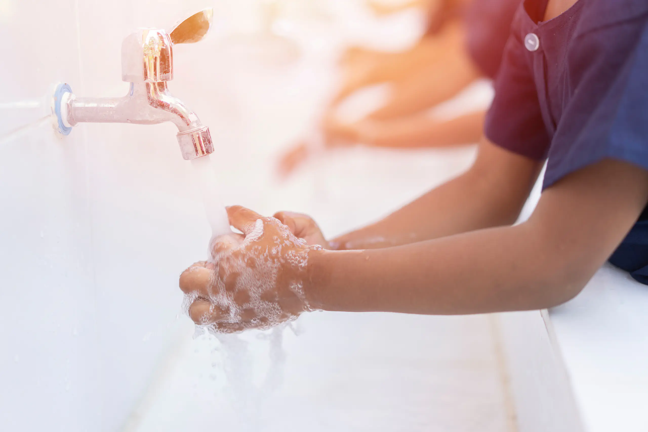 close up hands of children or Pupils At preschool Washing hands with soap under the faucet with water,copy space for text or product you. clean and Hygiene concept.Health and Wellbeing priority extension topic