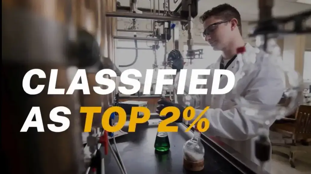 A man in a lab coat working with chemicals.