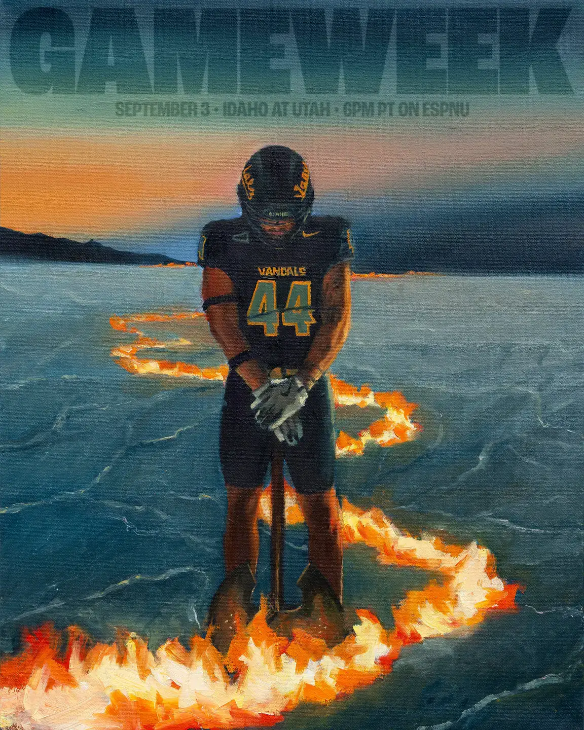 Football player in black uniform standing on the ground with a trail of fire around him and hills in the background.