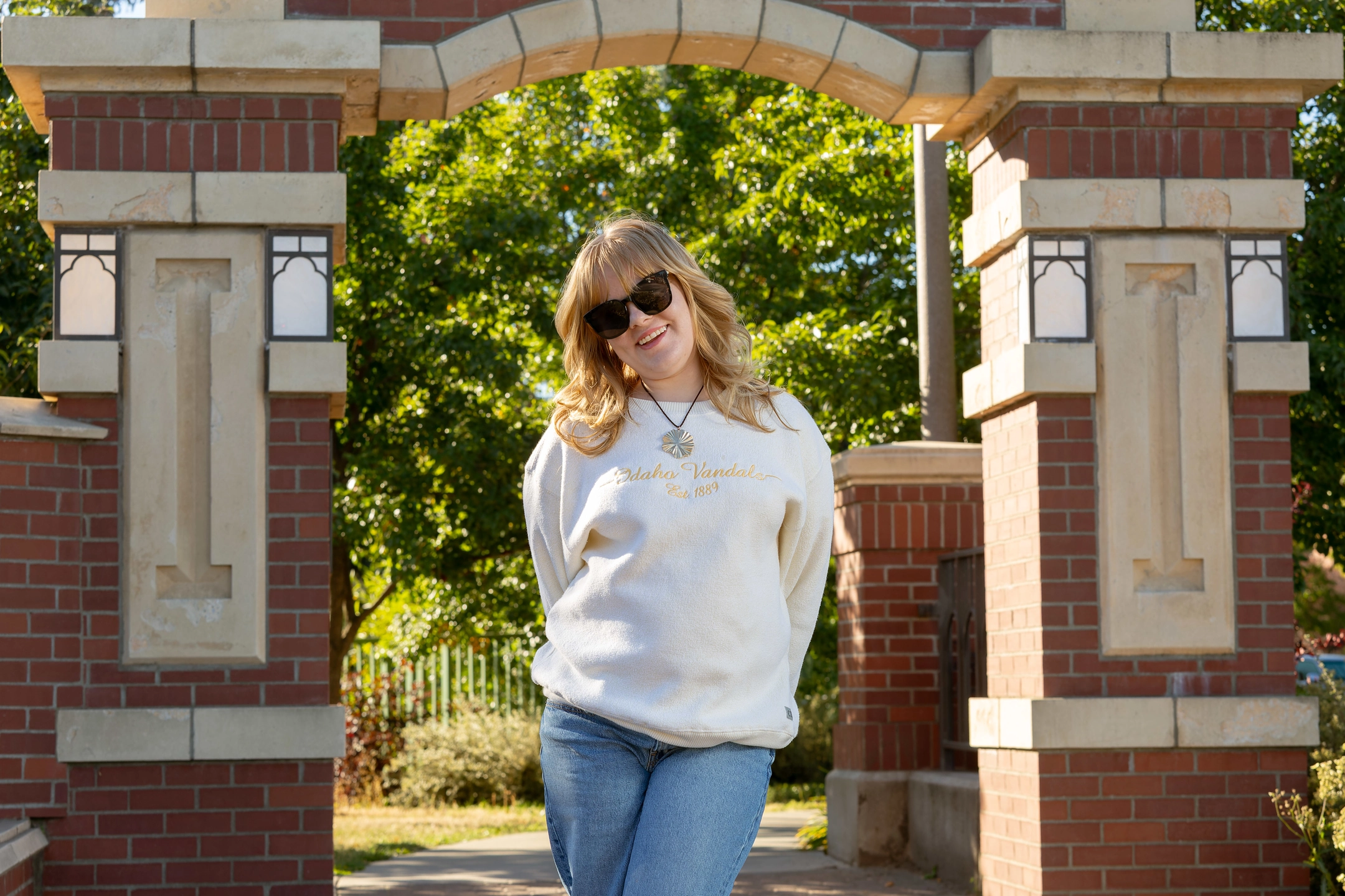 Jenna Partington wears sunglasses in front of U of I entrance.