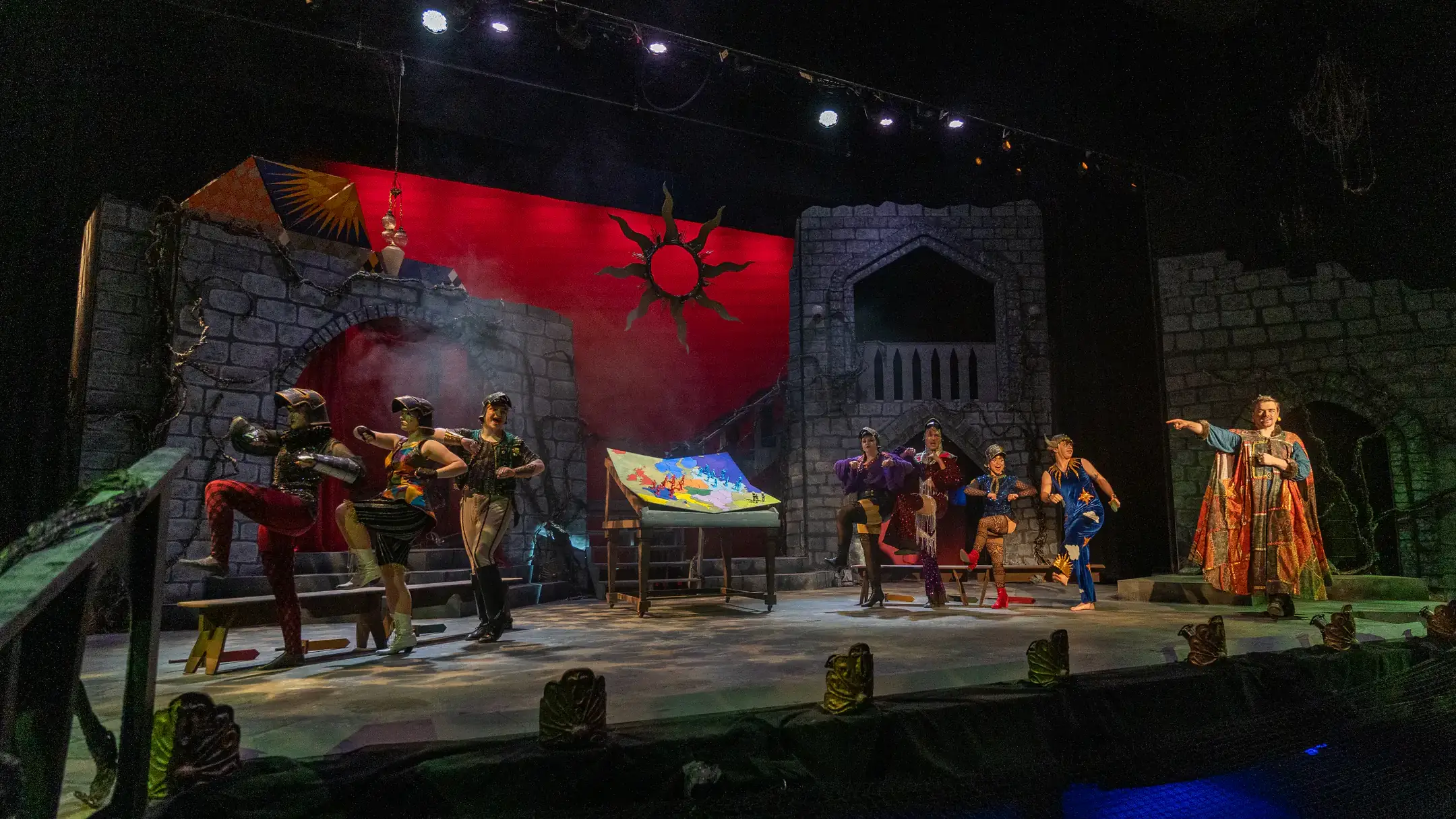 Cast members perform a musical number on a castle-themed stage during University of Idaho Theatre Arts’ production of “Pippin.”