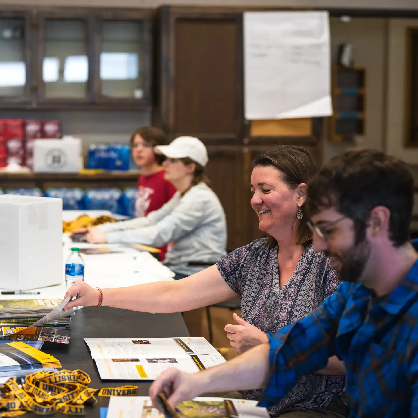 Volunteers prepare welcome folders for students competing at LHJF.  