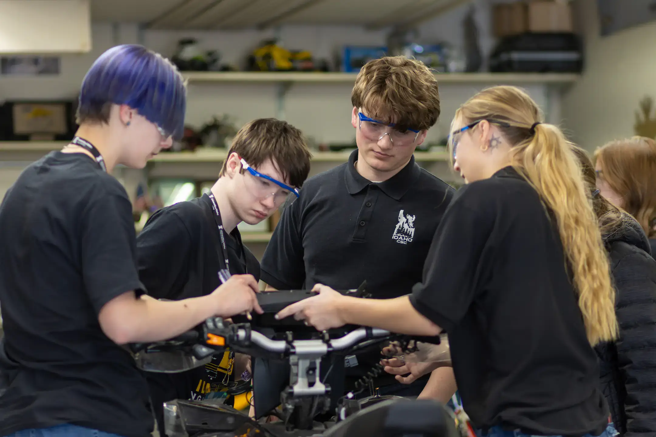 Four students work together on engineering a snowmobile