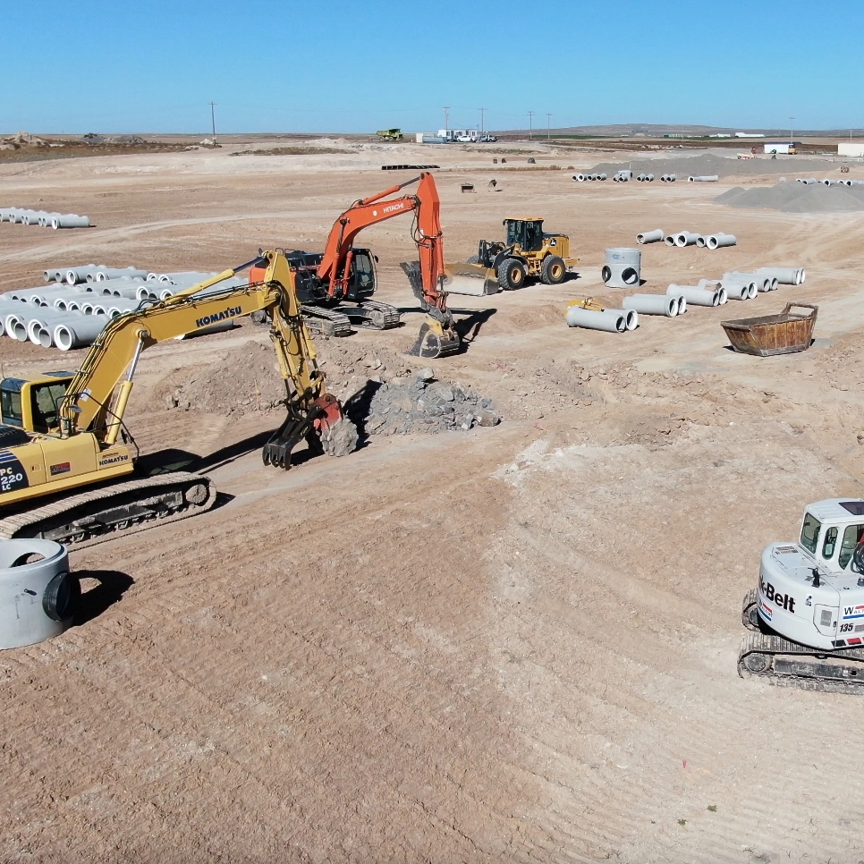 Three excavators working on a construction site