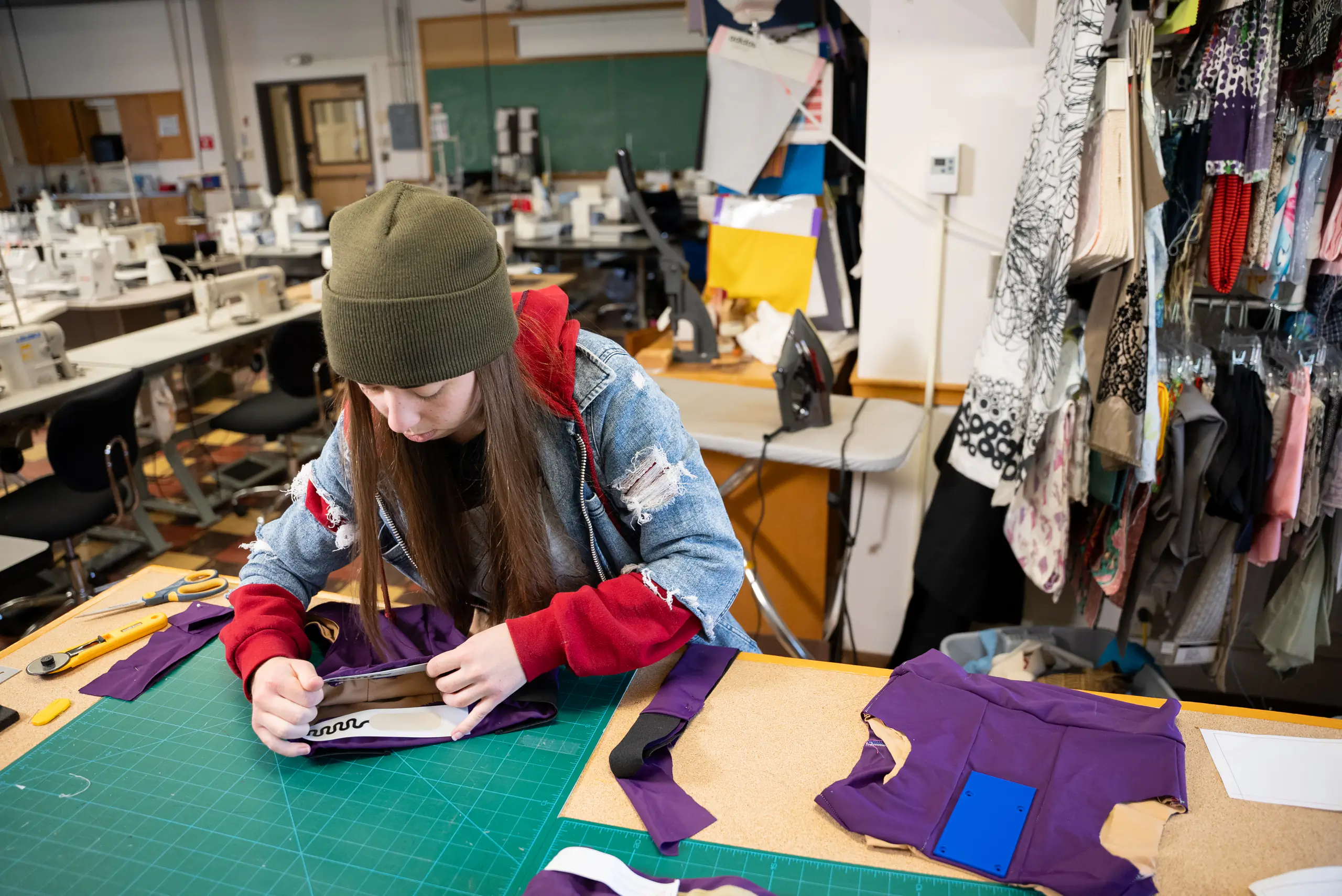 A person places a strip of sensors on the chest band of a sports bra.