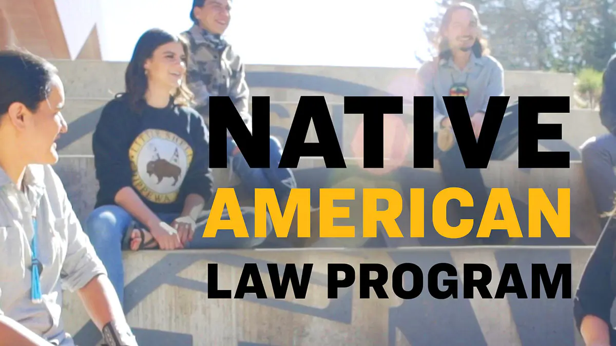 Students sitting out steps, talking and laughing amongst eachother.