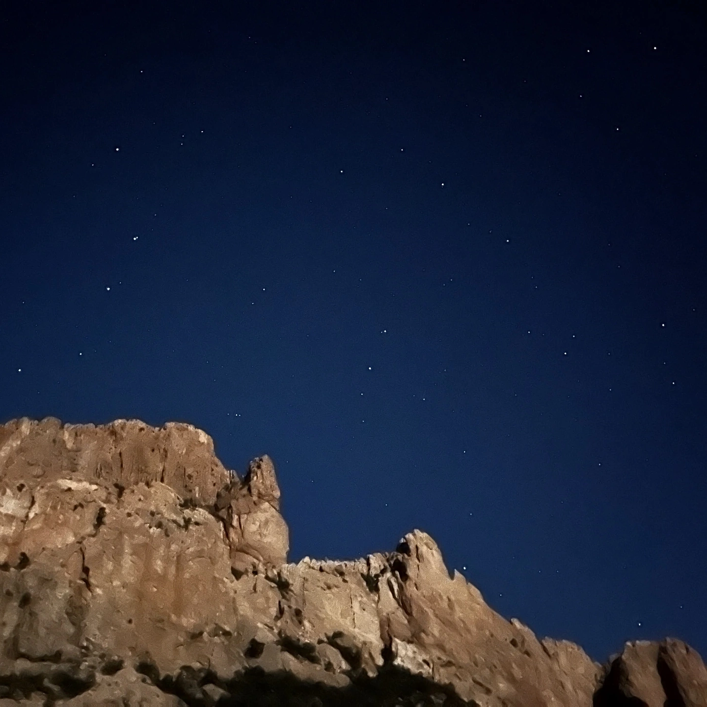 Starry night over a cliff