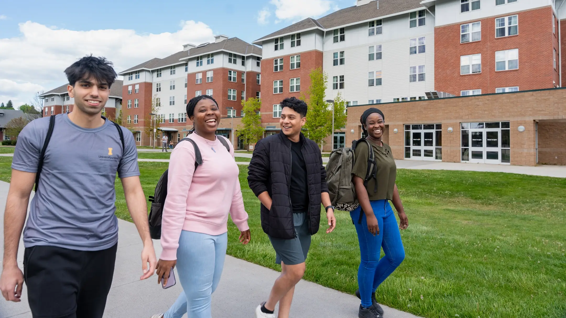 Students socialize and study in the Theophilus Tower Lawn outside Theophilus Tower and the Living Learning Community
