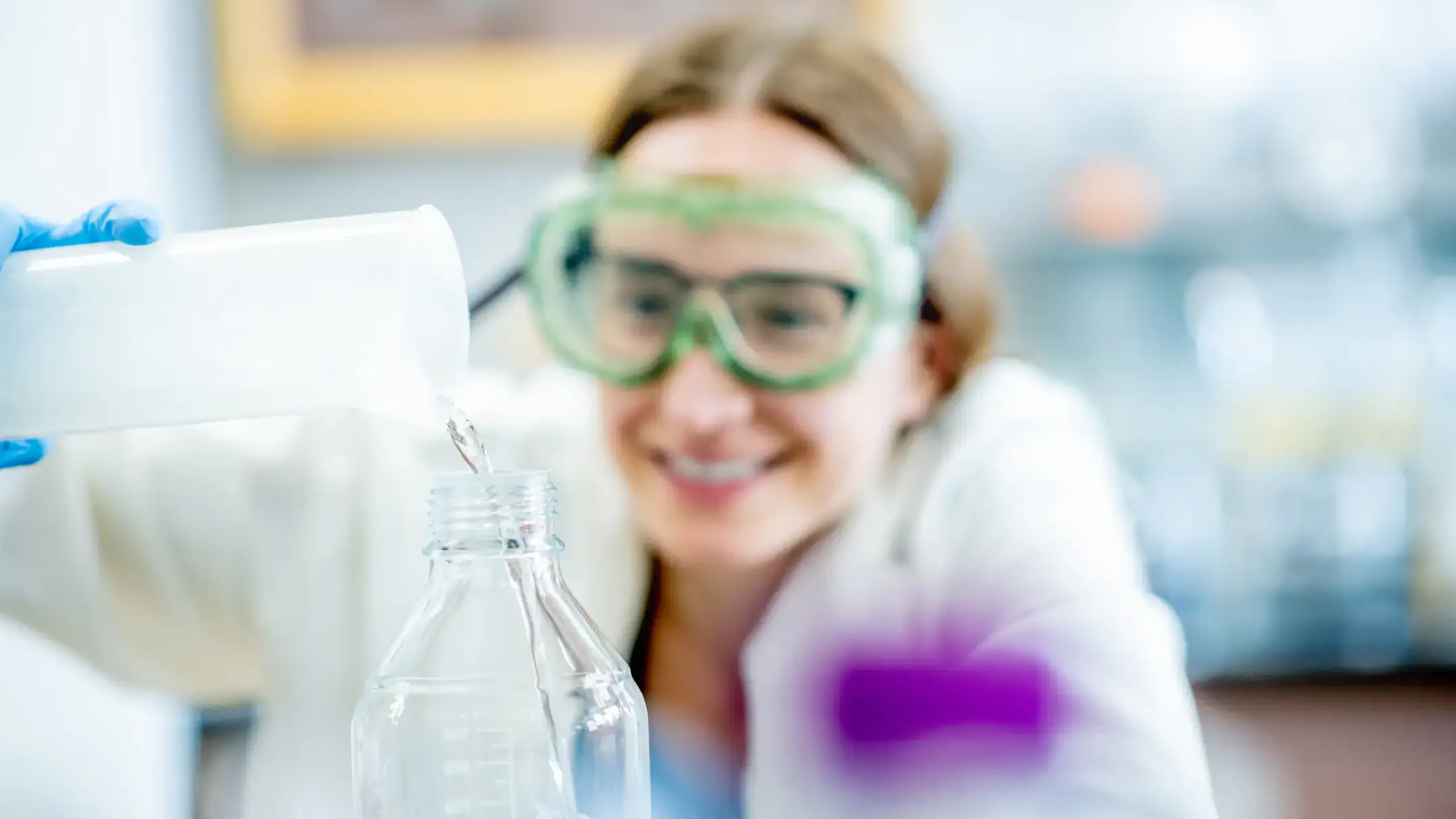 Molly Murphy a medical sciences student pouring chemicals in a lab.