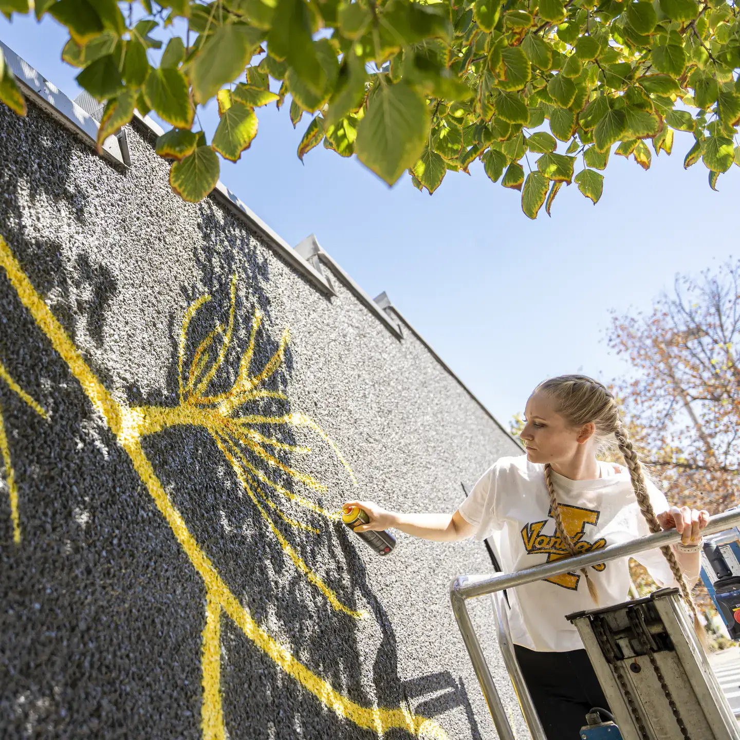 College of Art and Architecture Alumni, Mikaela Herrick, continuing the mural painted on the Prichard Art Gallery downtown Moscow, Idaho.