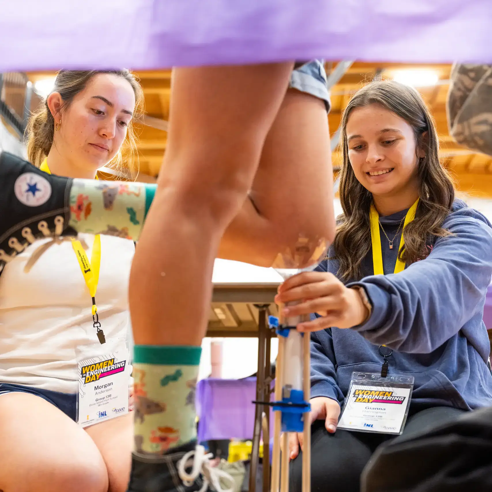 Two girls holding up measuring vials