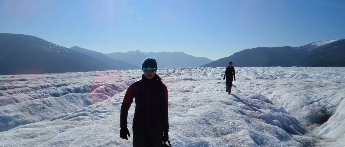 two people trudging over an icy landscape