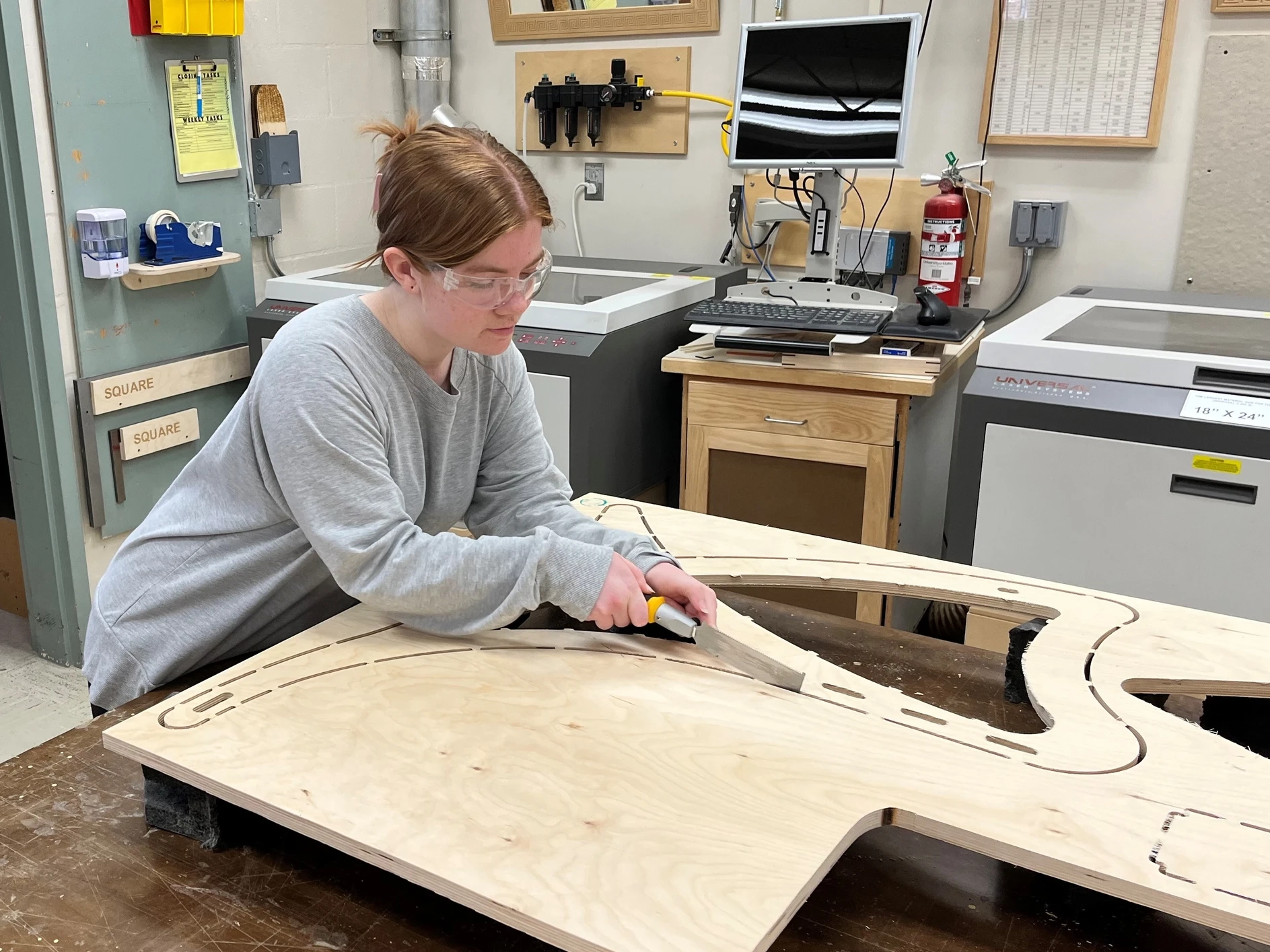 Ainsley Bauer cutting wood