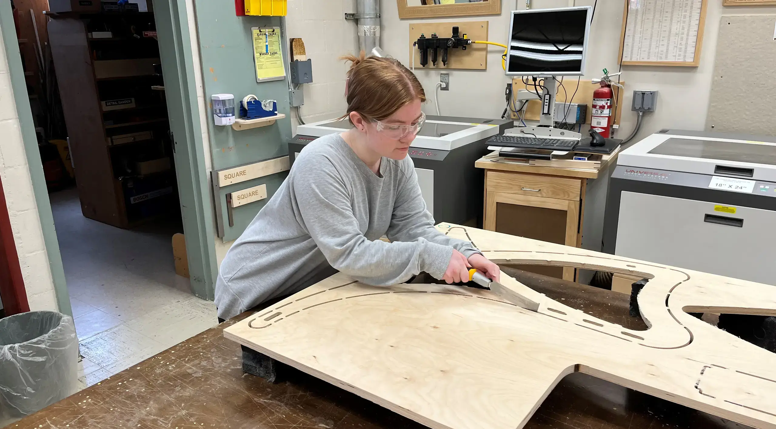 Ainsley Bauer cutting wood
