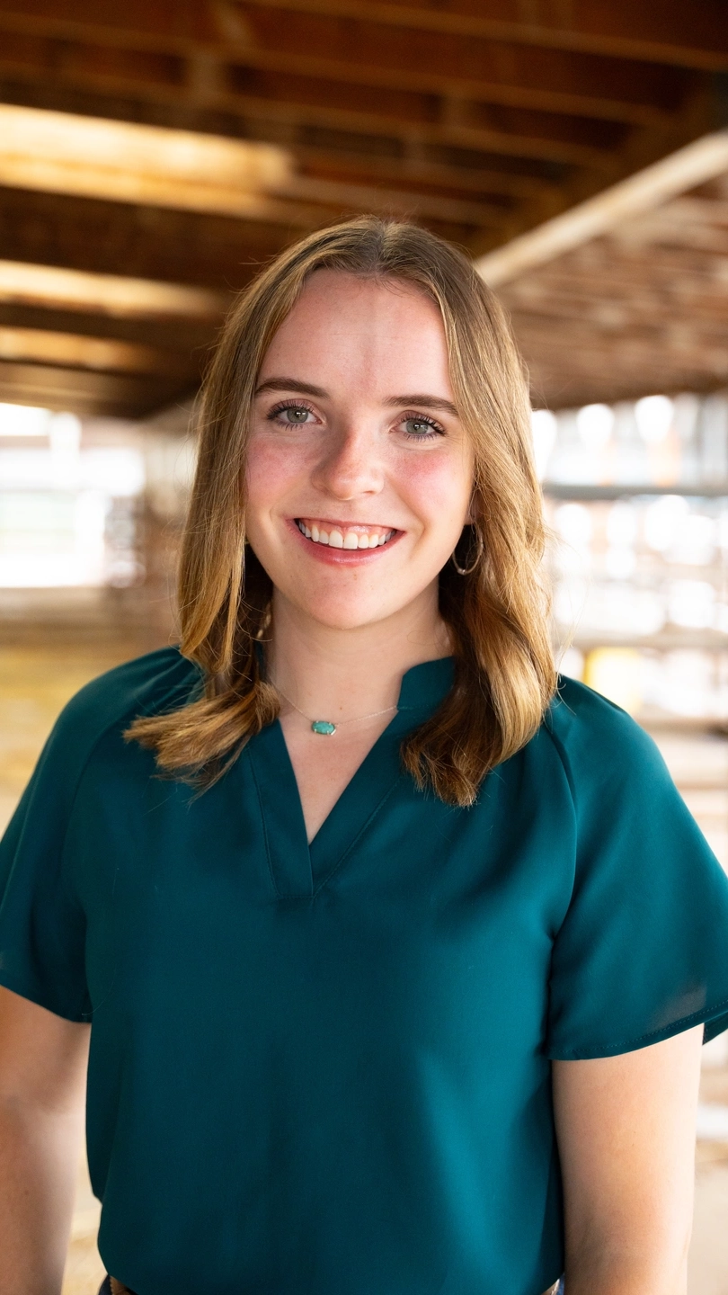 A portrait of a woman in a barn.