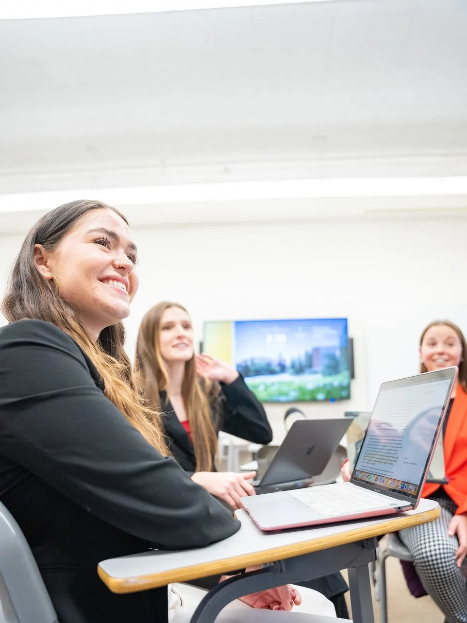 U of I students sitting in a classroom interacting with an instructor. 
