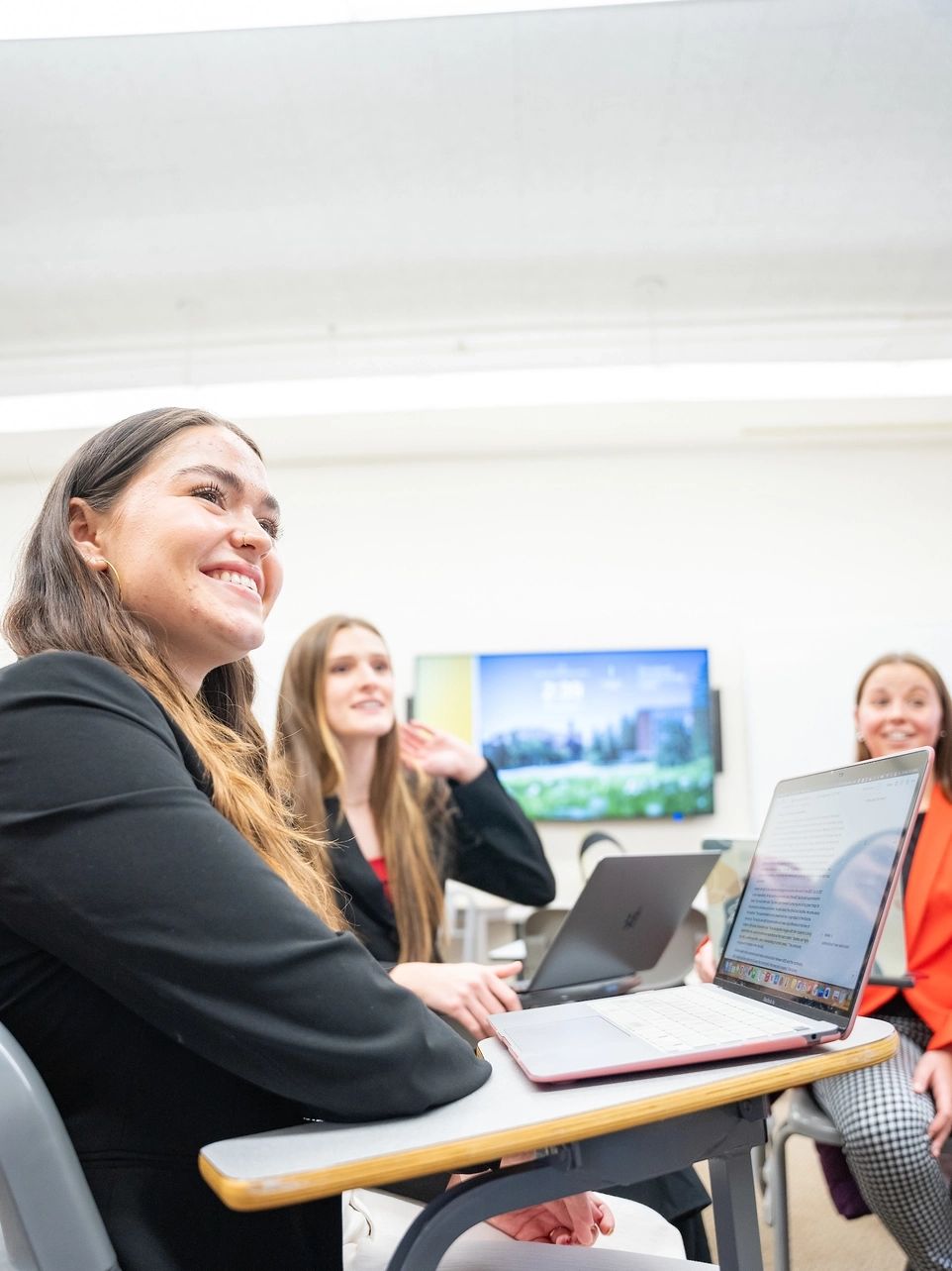 U of I students sitting in a classroom interacting with an instructor. 