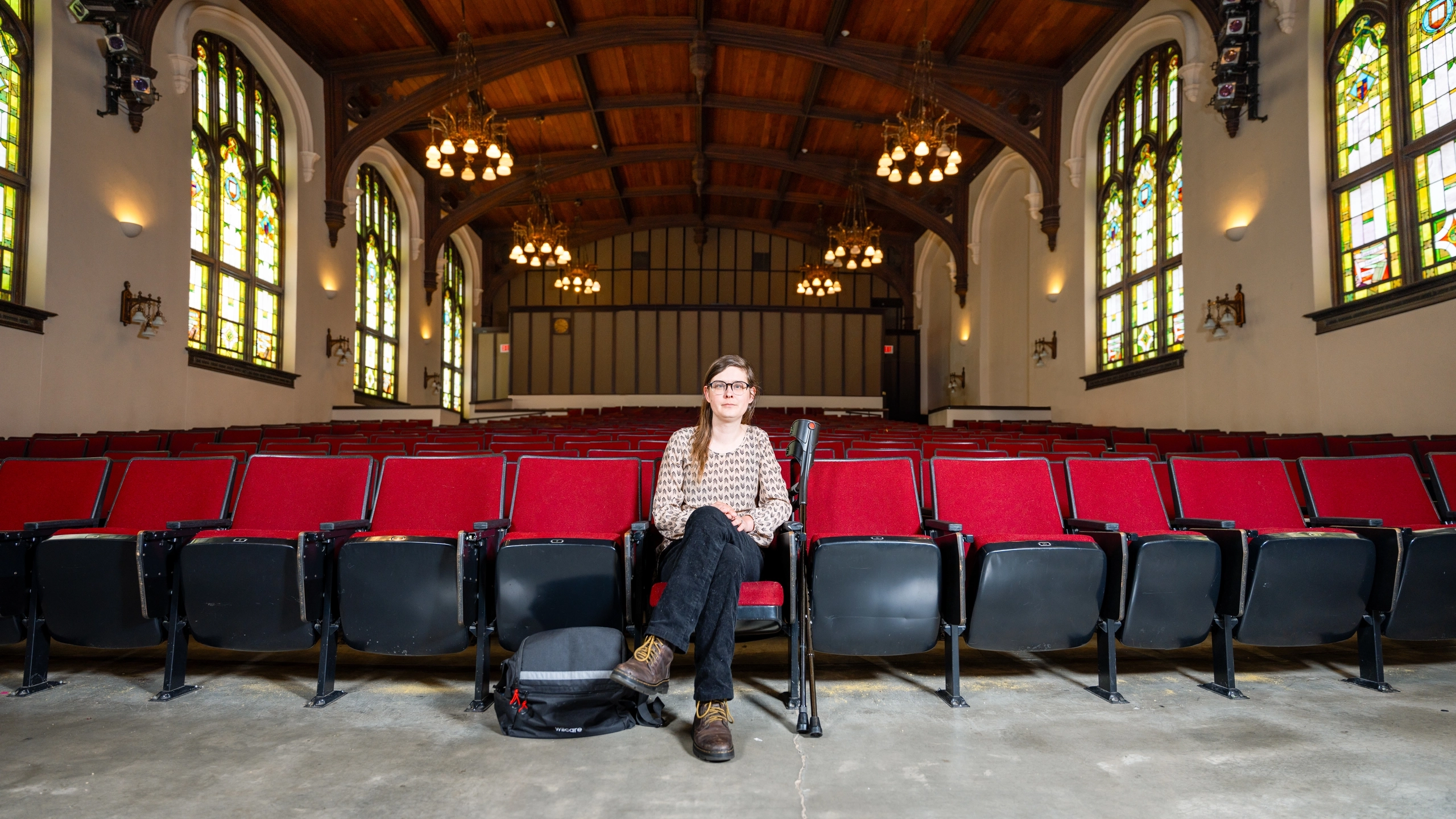 Woman sitting in an empty theater