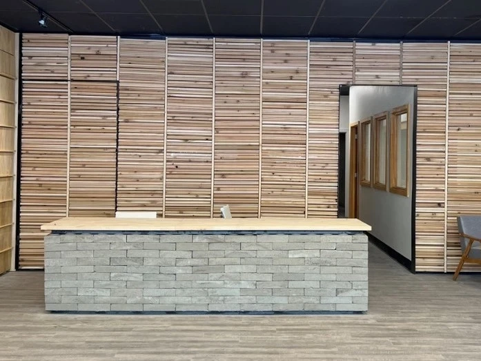 Brick desk and wood walls behind it