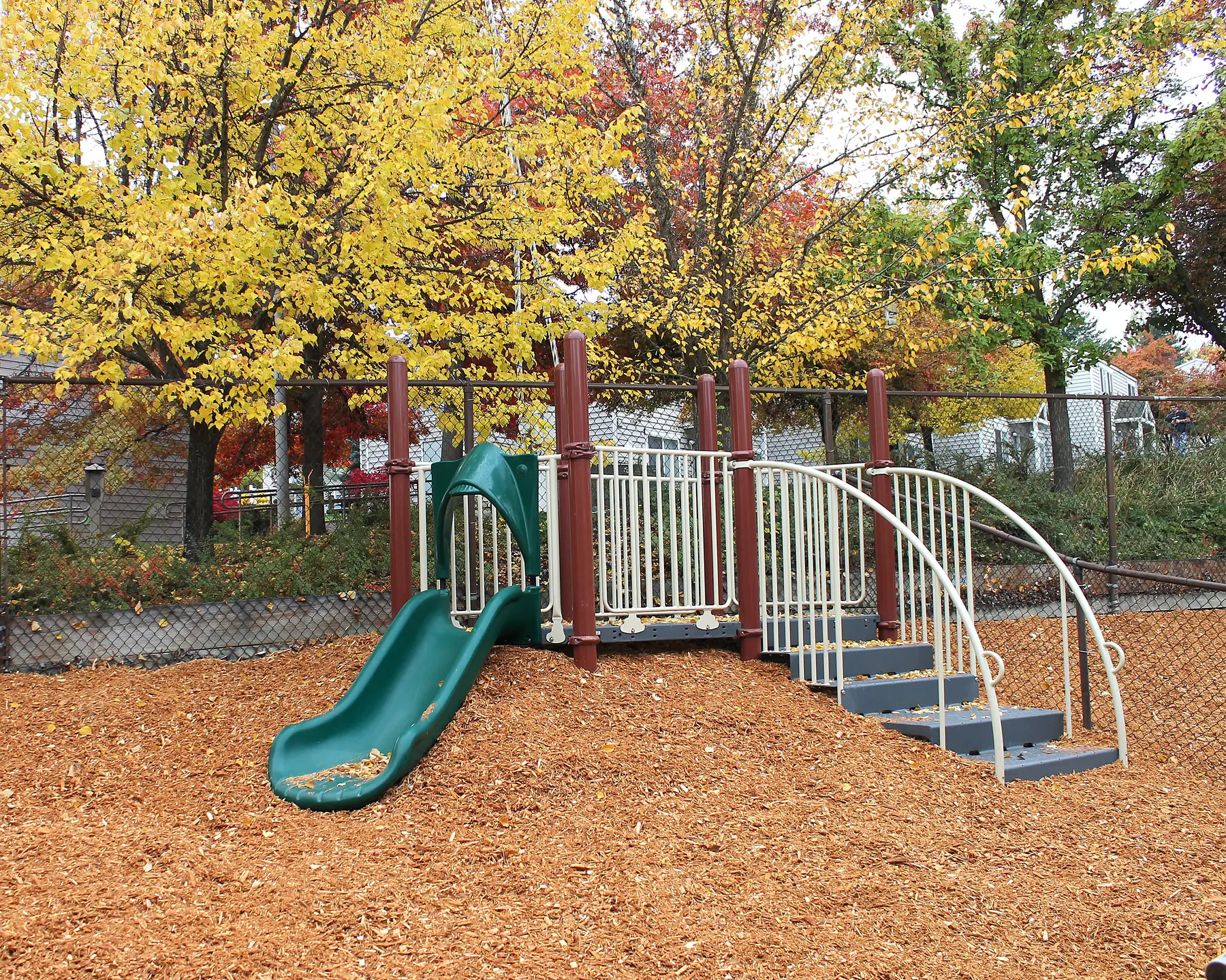 A playground with jungle gym and slide for toddlers