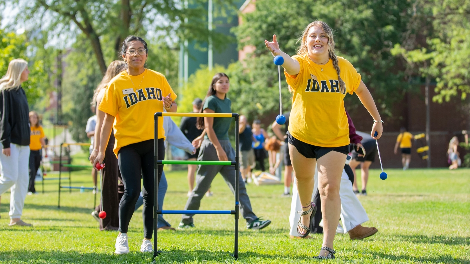 Student play a game on the Theophilus Tower lawn during fall student orientation.