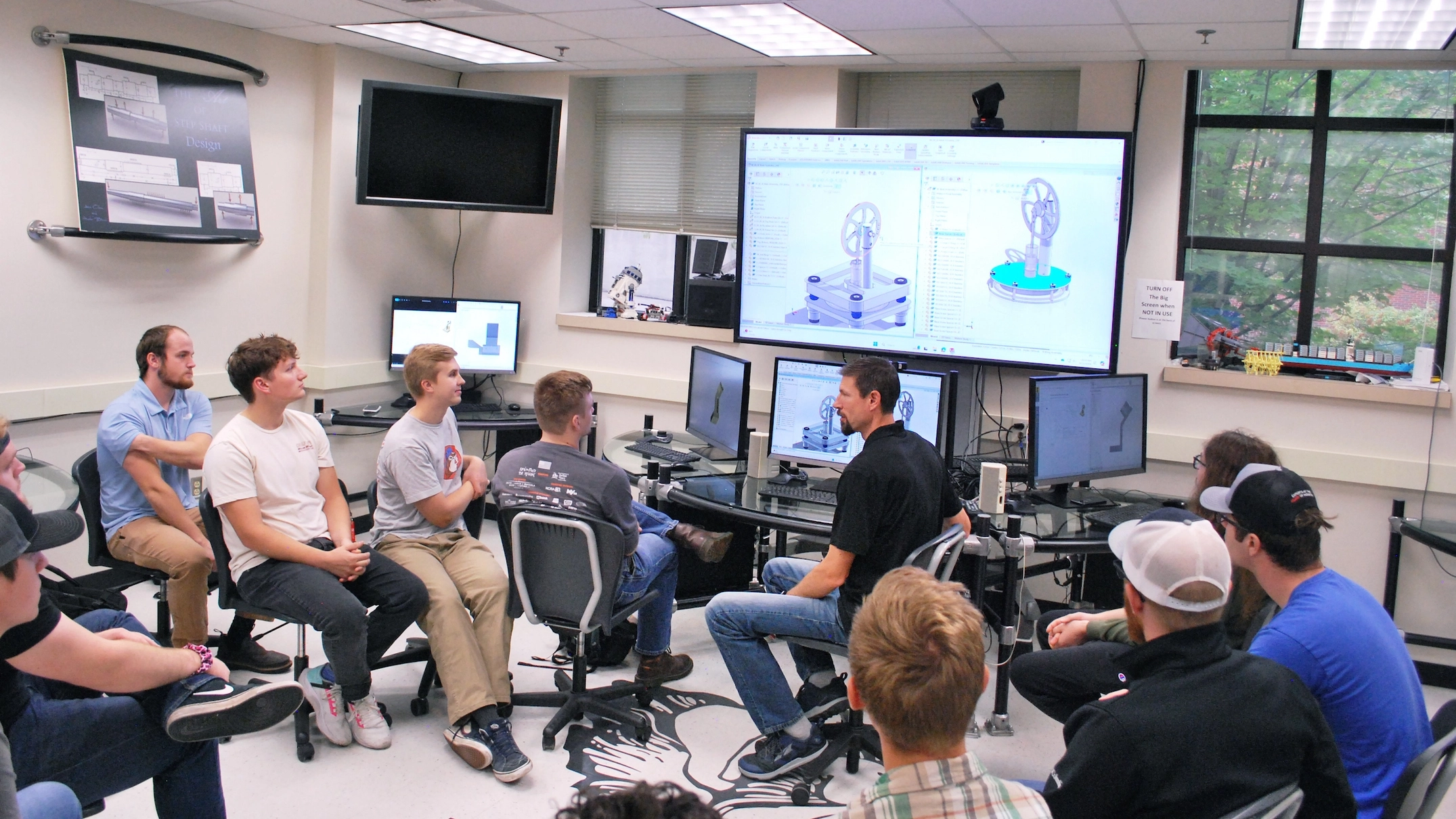 U of I College of Engineering students discuss computer aided design alterations