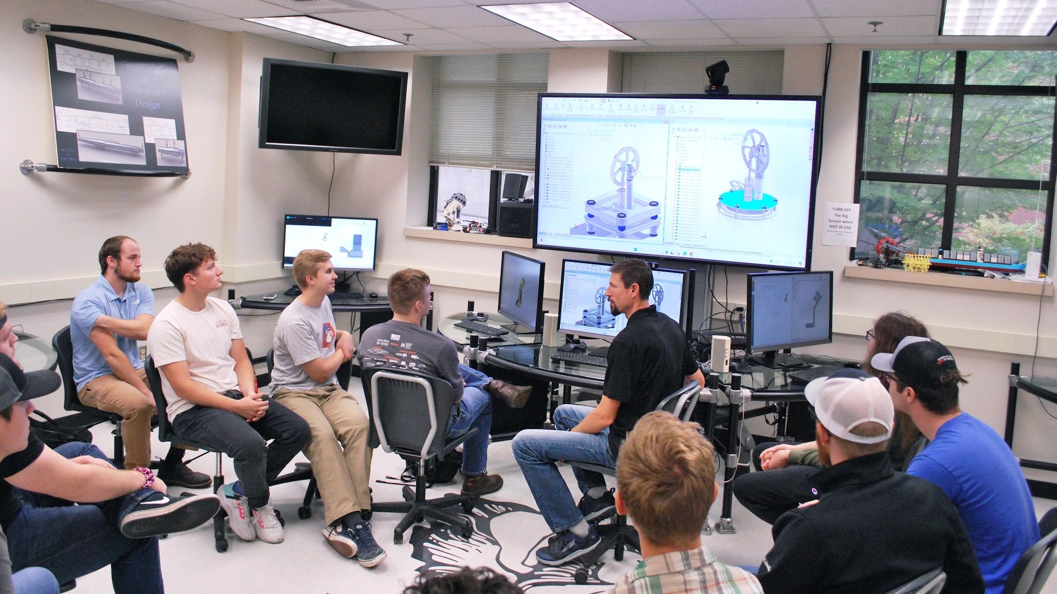 U of I College of Engineering students discuss computer aided design alterations
