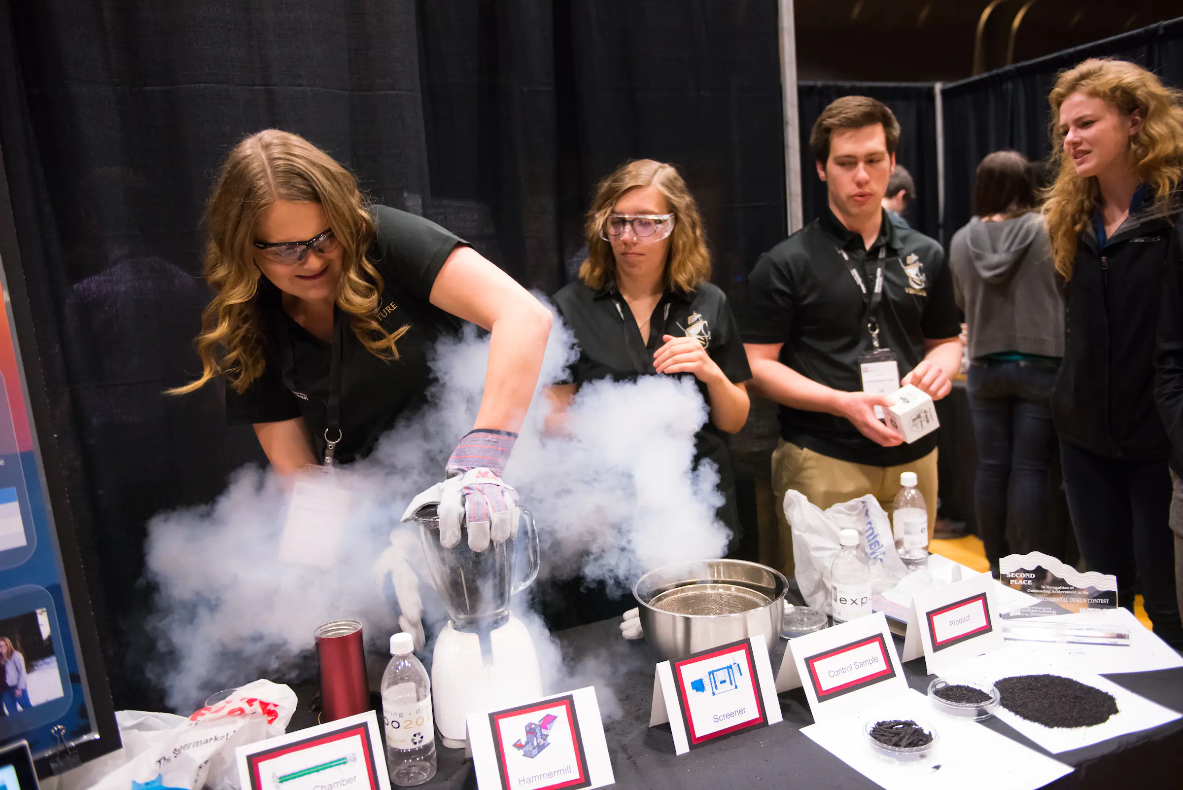 Girl at Engineering Capstone showcasing her chemical reaction project