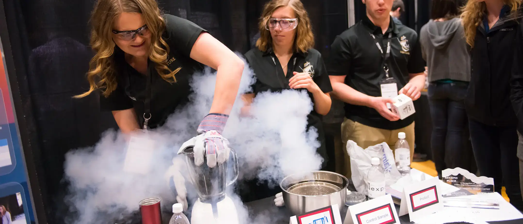 Girl at Engineering Capstone showcasing her chemical reaction project