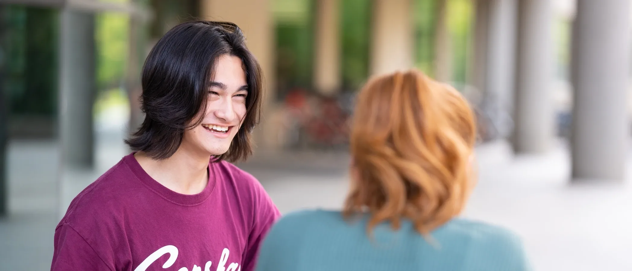University of Idaho student in the outdoor seating area in University of Idaho Library plaza.