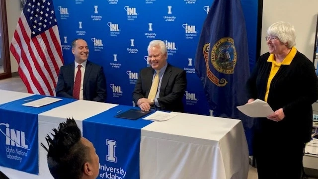Scott Green sits a table with INL and University of Idaho logos.