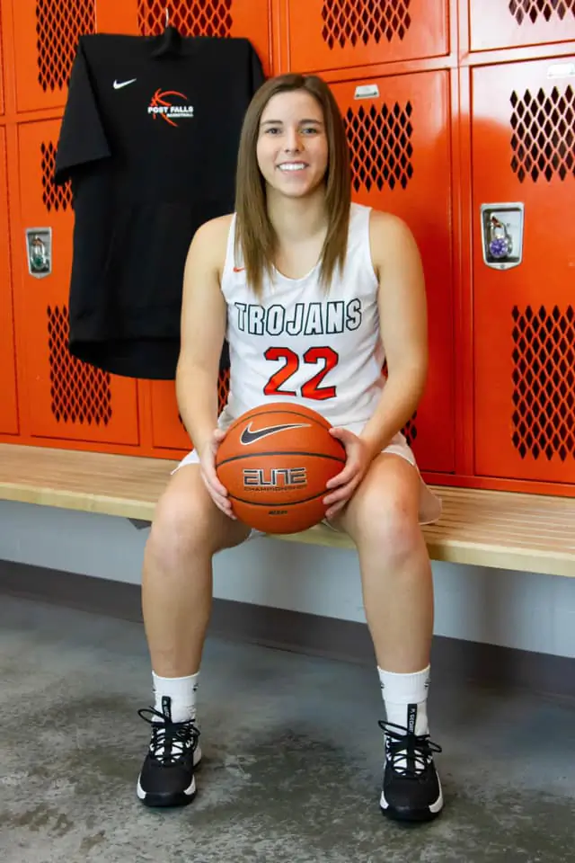 Kennedy LaFountaine wears a Trojans basketball jersey in the locker room