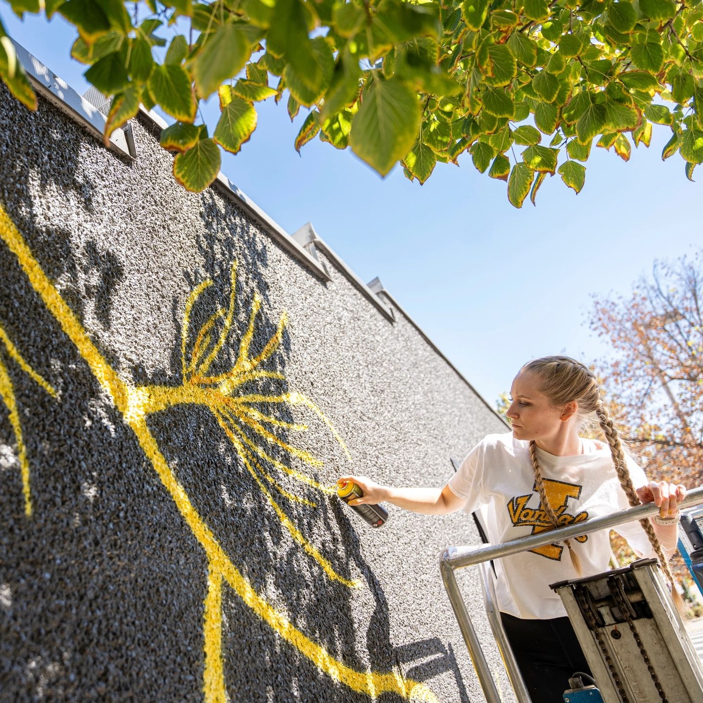 College of Art and Architecture Alumni, Mikaela Herrick, continuing the mural painted on the Prichard Art Gallery downtown Moscow, Idaho