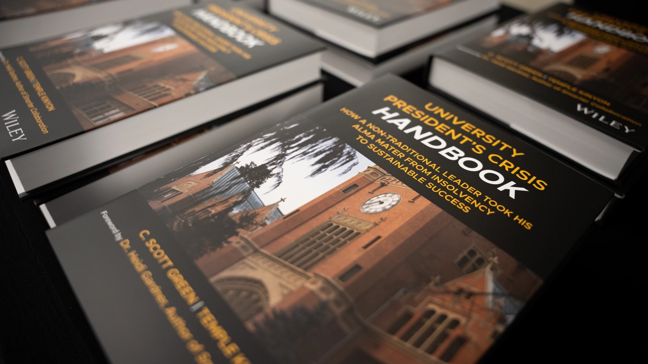 Many University Presidents Crisis Handbooks sitting on a table