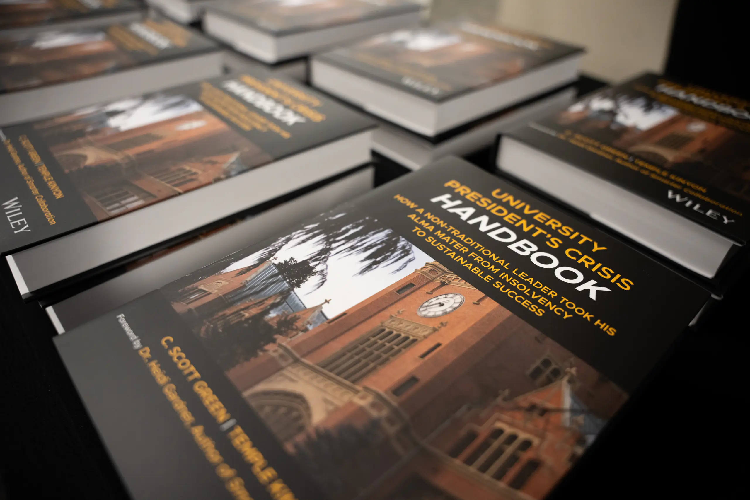 Many University Presidents Crisis Handbooks sitting on a table