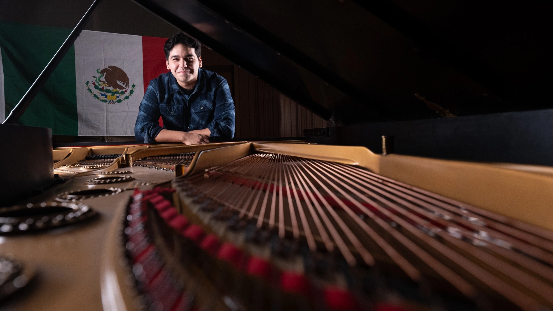 Alex Aguilar plays the piano in the Haddock Recital Hall at the Lionel Hampton Music Building