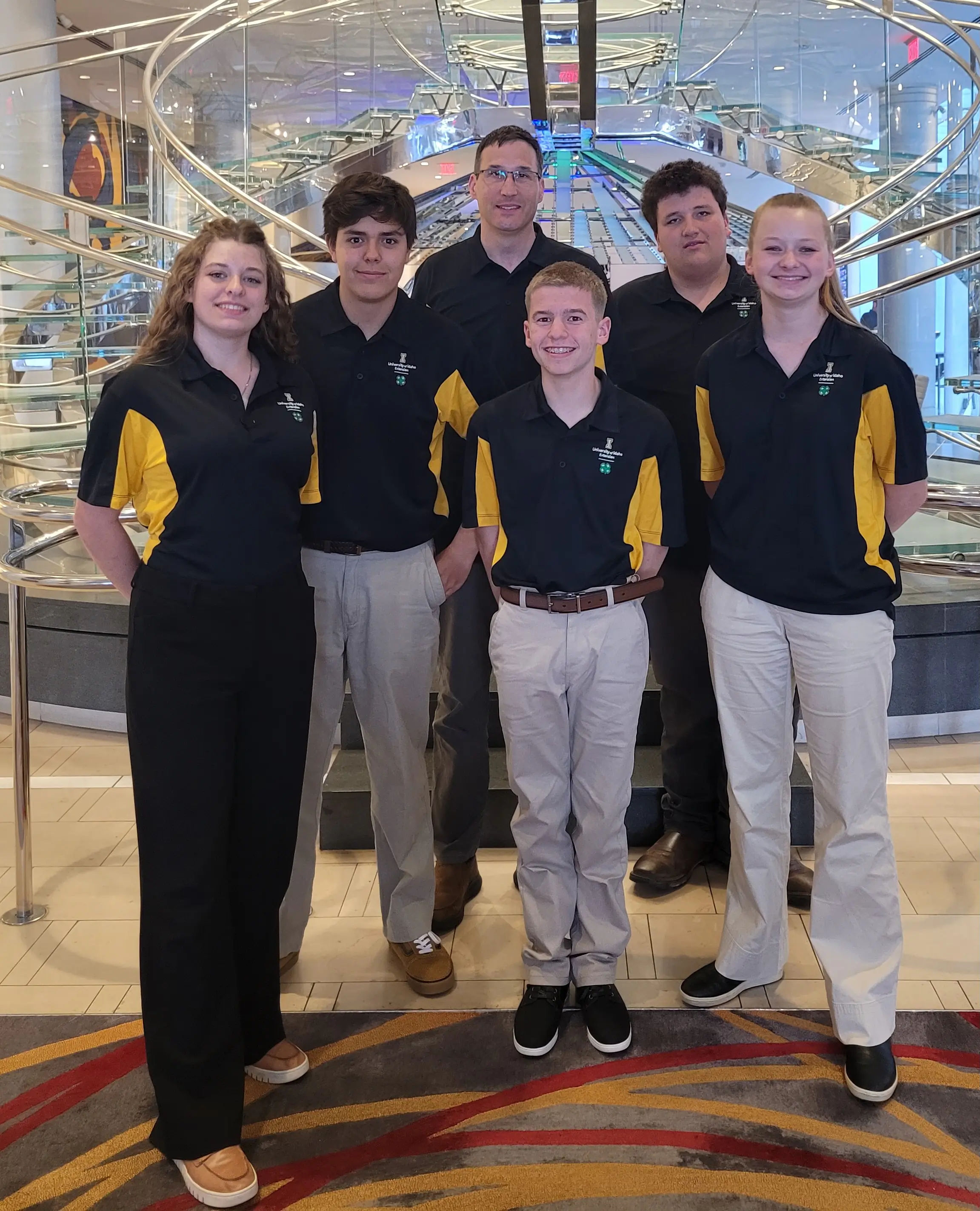 Six people smiling while wearing U of I polos