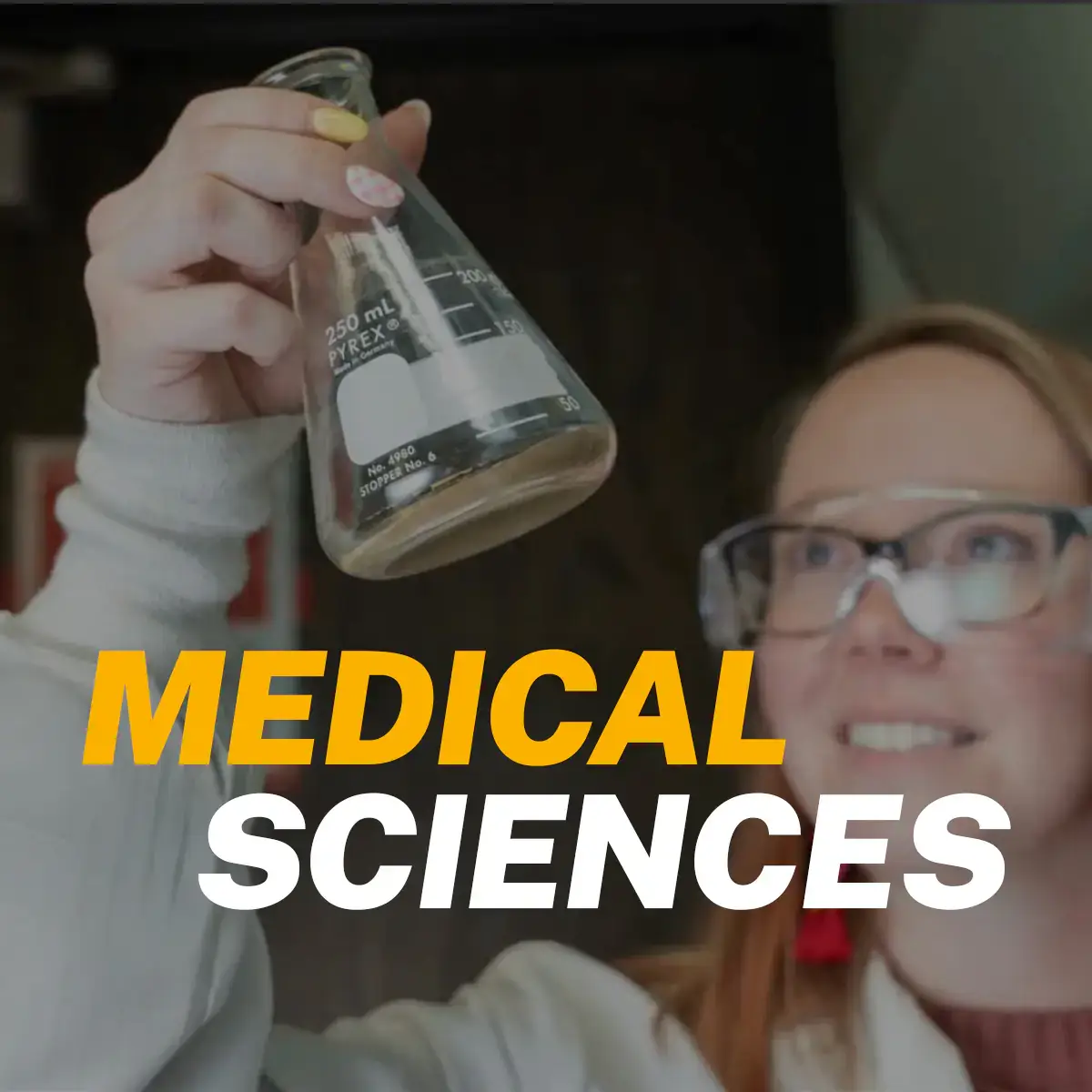 Scientist holding up vial with the words "Medical sciences"