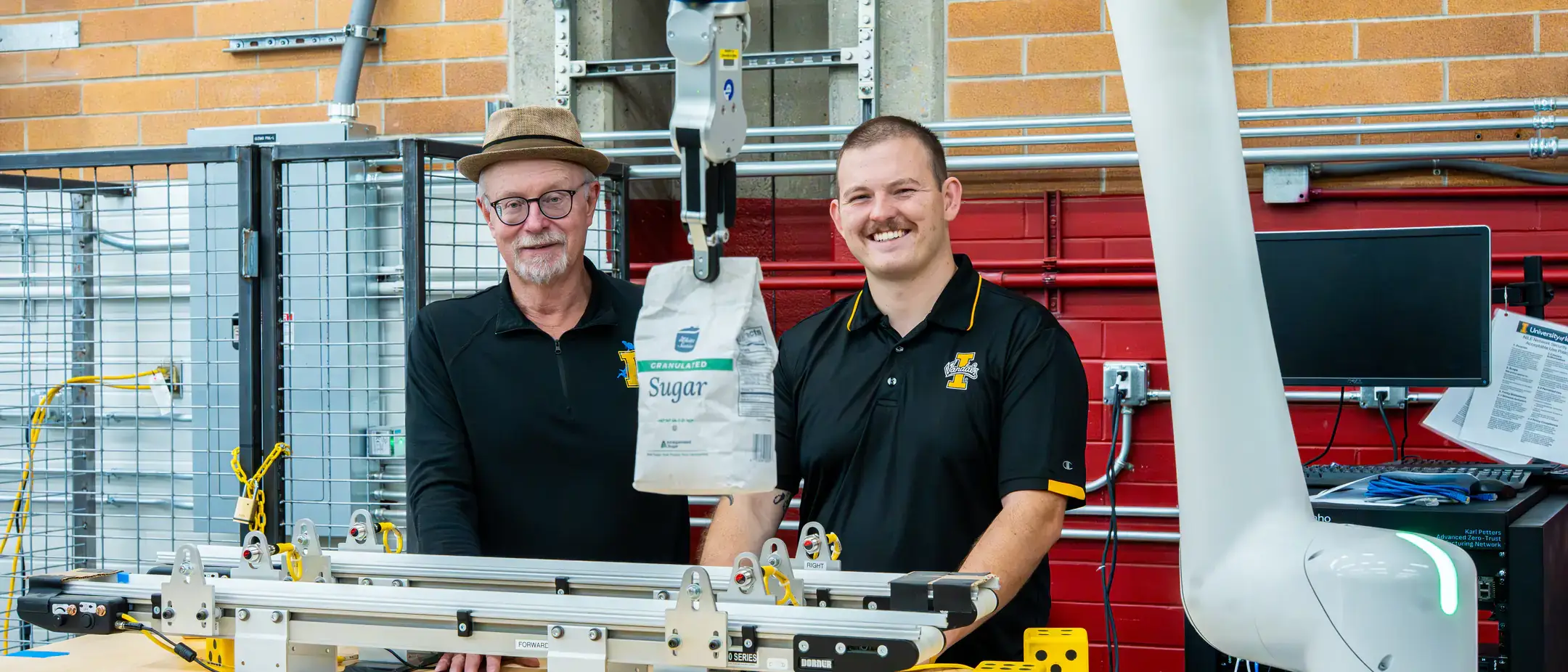 Engineering students and faculty are developing AI-driven automation solutions for Amalgamated Sugar to keep the plant's assembly line from breaking down while adding components to maintain moisture levels in sugar beets, helping the company improve productivity and optimizing both quality and quantity. Pictured from left are computer science graduate student Hunter Hawkins and research faculty John Shovic.