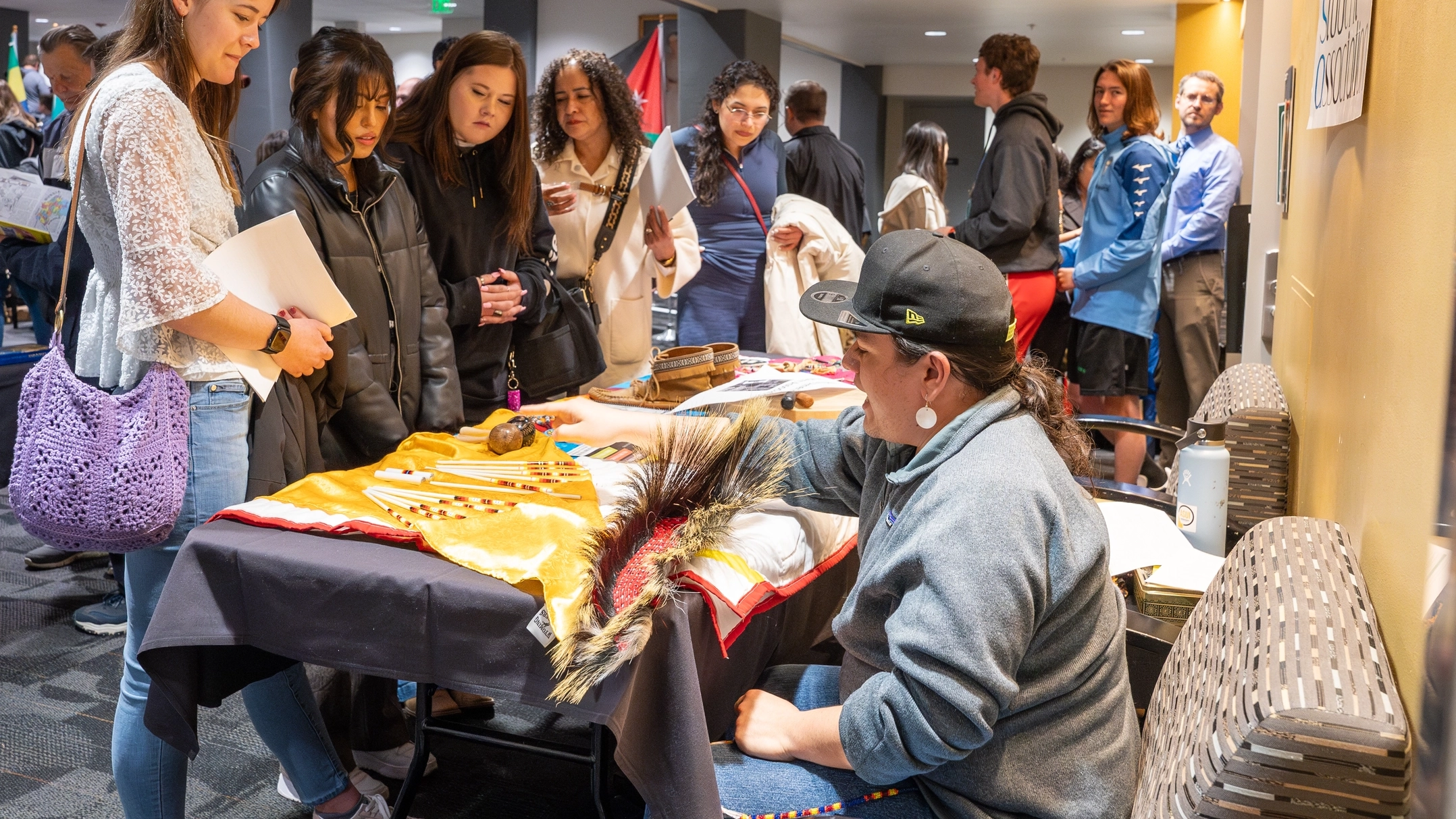 A volunteer shares information about their culture at a booth