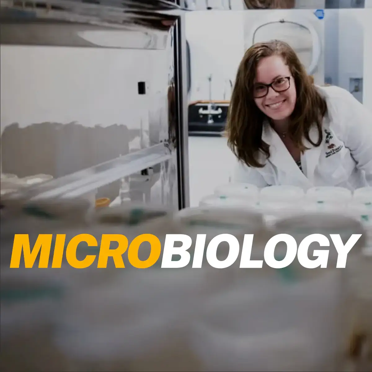 Microbiology over a backdrop of a woman smiling while carrying petri dishes