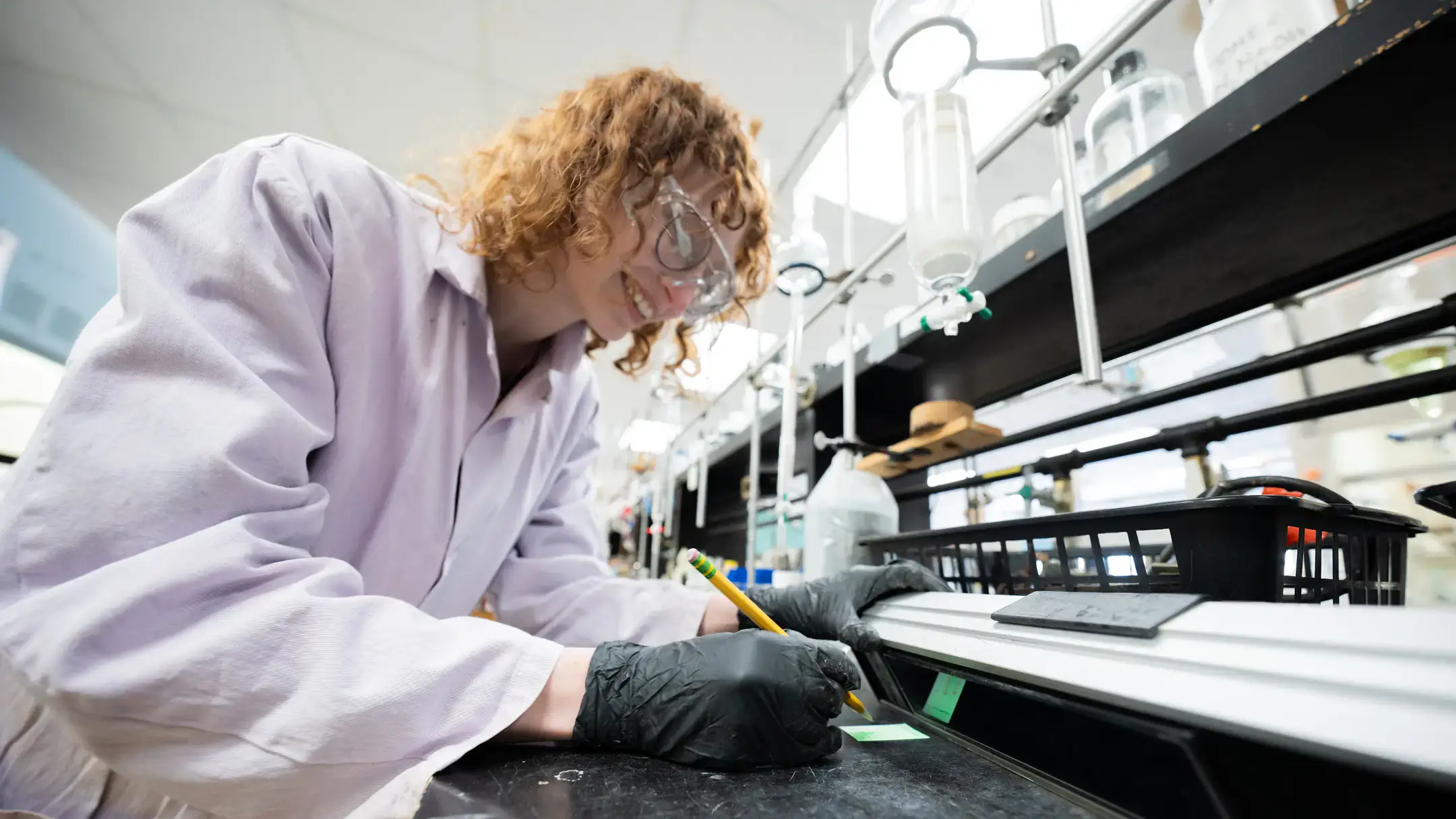 Maddie Moody works in a fume hood separating elements in Dr. Wandruszka's Lab in Renfrew Hall on the University of Idaho campus.