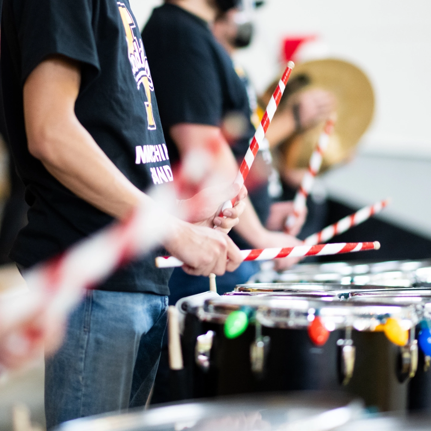 A band using candy cane inspired drumsticks during a performance