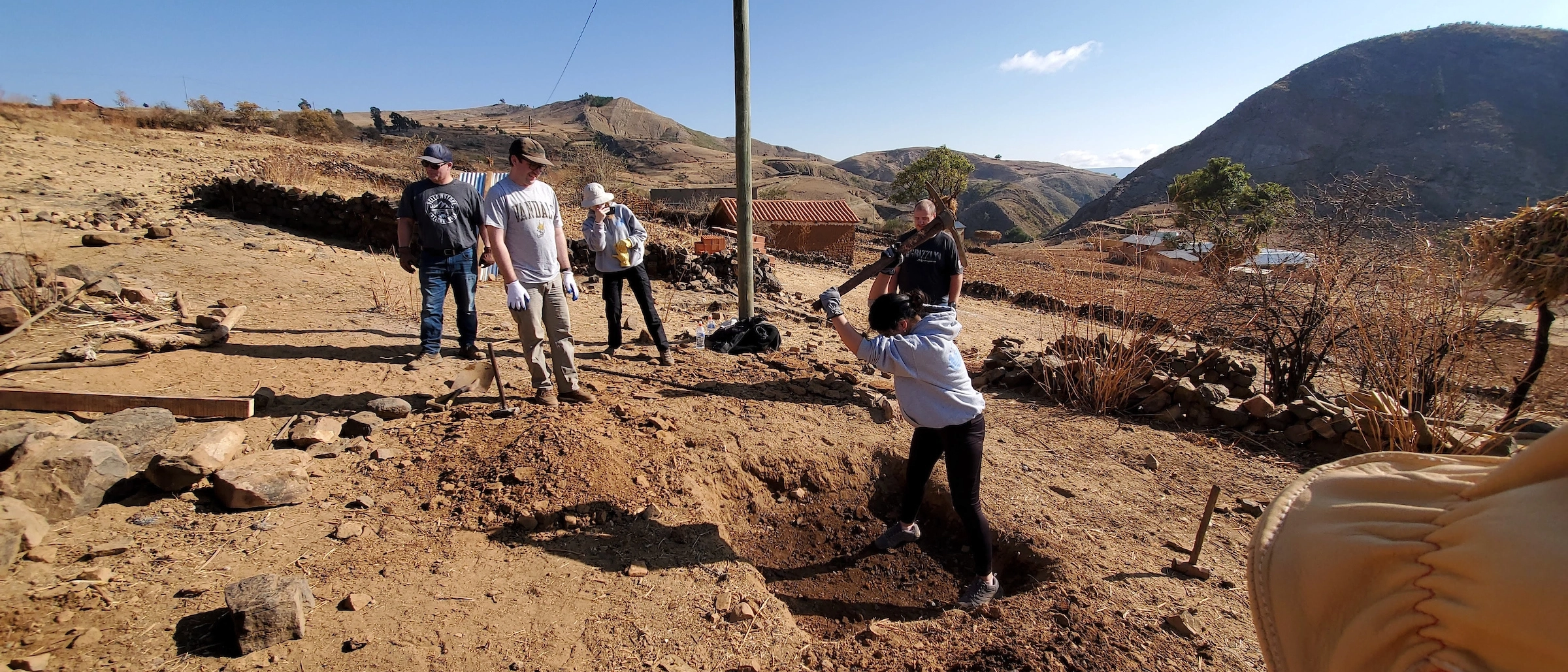 U of I student participating in an archaeological dig on a mountain side. 