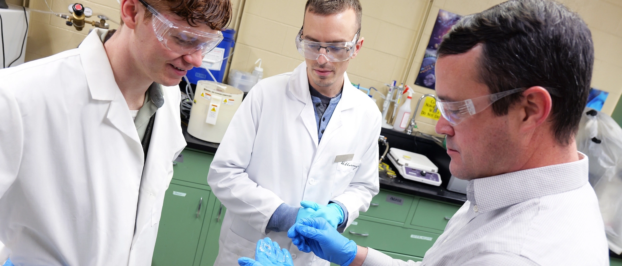 University of Idaho chemistry student Thomas Hersey (left to right), graduate student Parker Dubee and Chemical Engineering Associate Professor Matthew Bernards analyze a biomaterial capable of isolating specific signals that encourage cells to form into tendon. The University of Idaho is leveraging three unique laboratory capabilities in an interdisciplinary effort to grow our understanding of human tendon development and healing after injury.